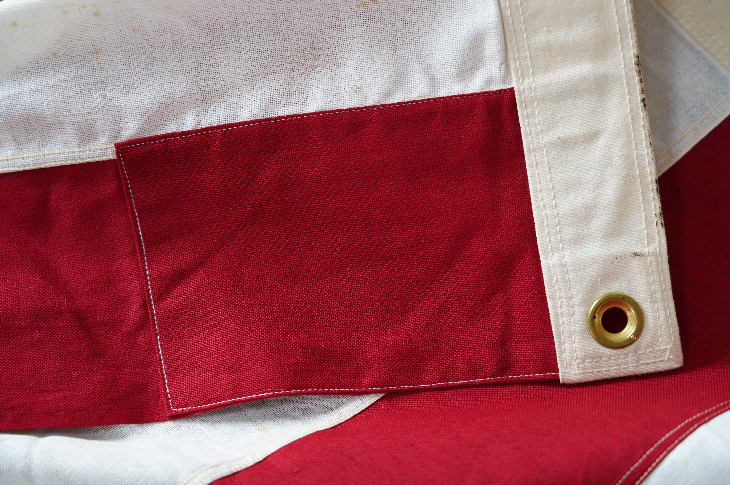 Four flags; two professionally made US Stars and Stripes, both on thick canvas with applied stars and joined stripes, one by the Valley Forge Flag Co., Pennsylvania, stamped “5 x 9.5 ft”, 146 x 288cm and 176 x 300cm, tog